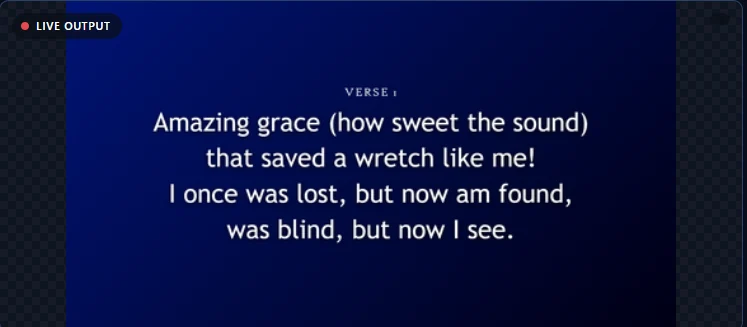The clean presentation output as the congregation sees it, showing a hymn verse on a deep blue gradient background.